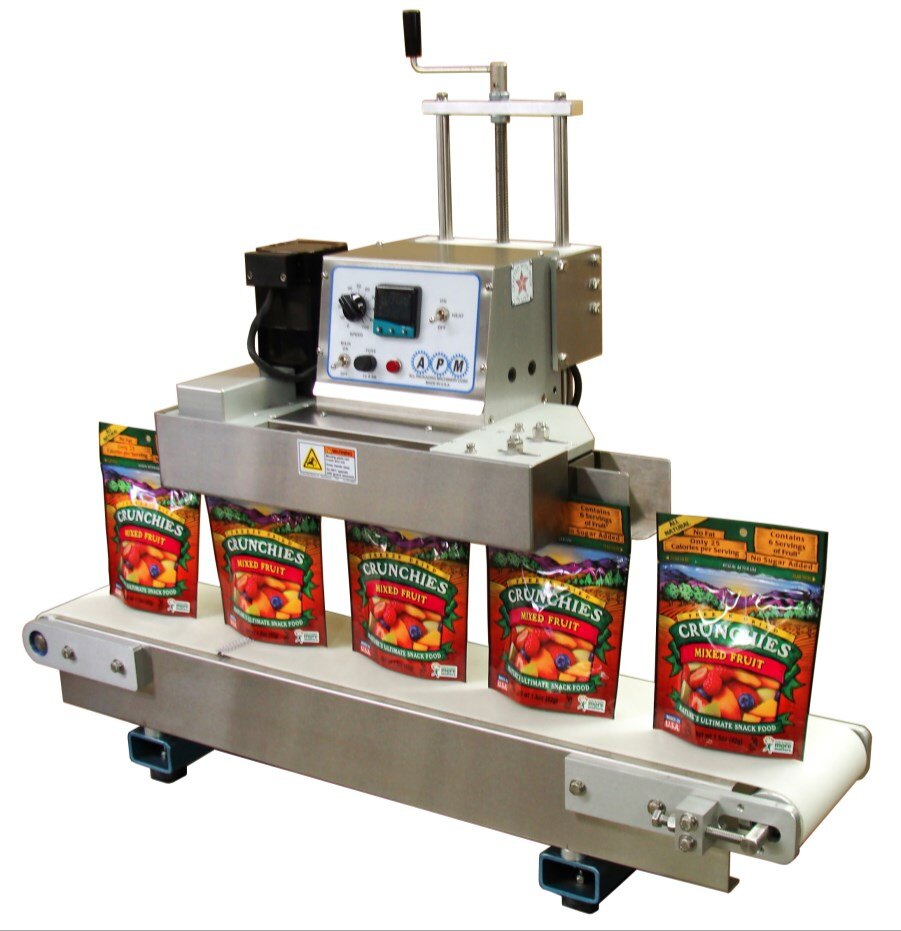 APM TCBSDM 3/8 tabletop conveyorized band sealer with crank handle height adjustment, sealing stand up pouches on its conveyor