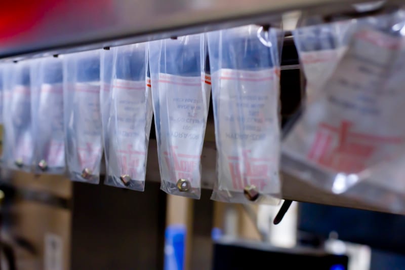 Sealed bags coming off an automatic bagging line