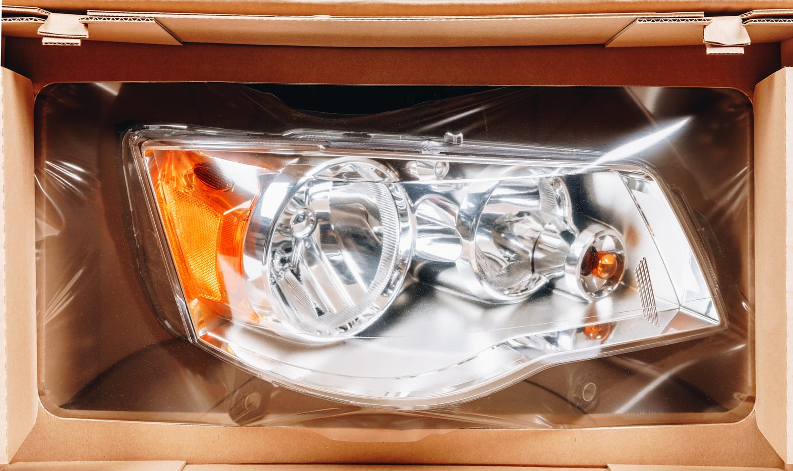 A headlamp suspended in a Korrvu retention pack inside its shipping carton