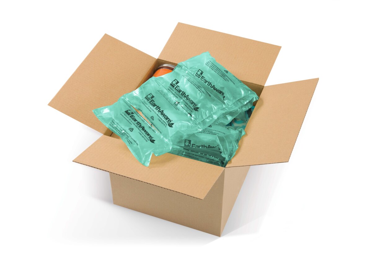 Open shipping carton filled with green AirPouch EarthAware air pillows