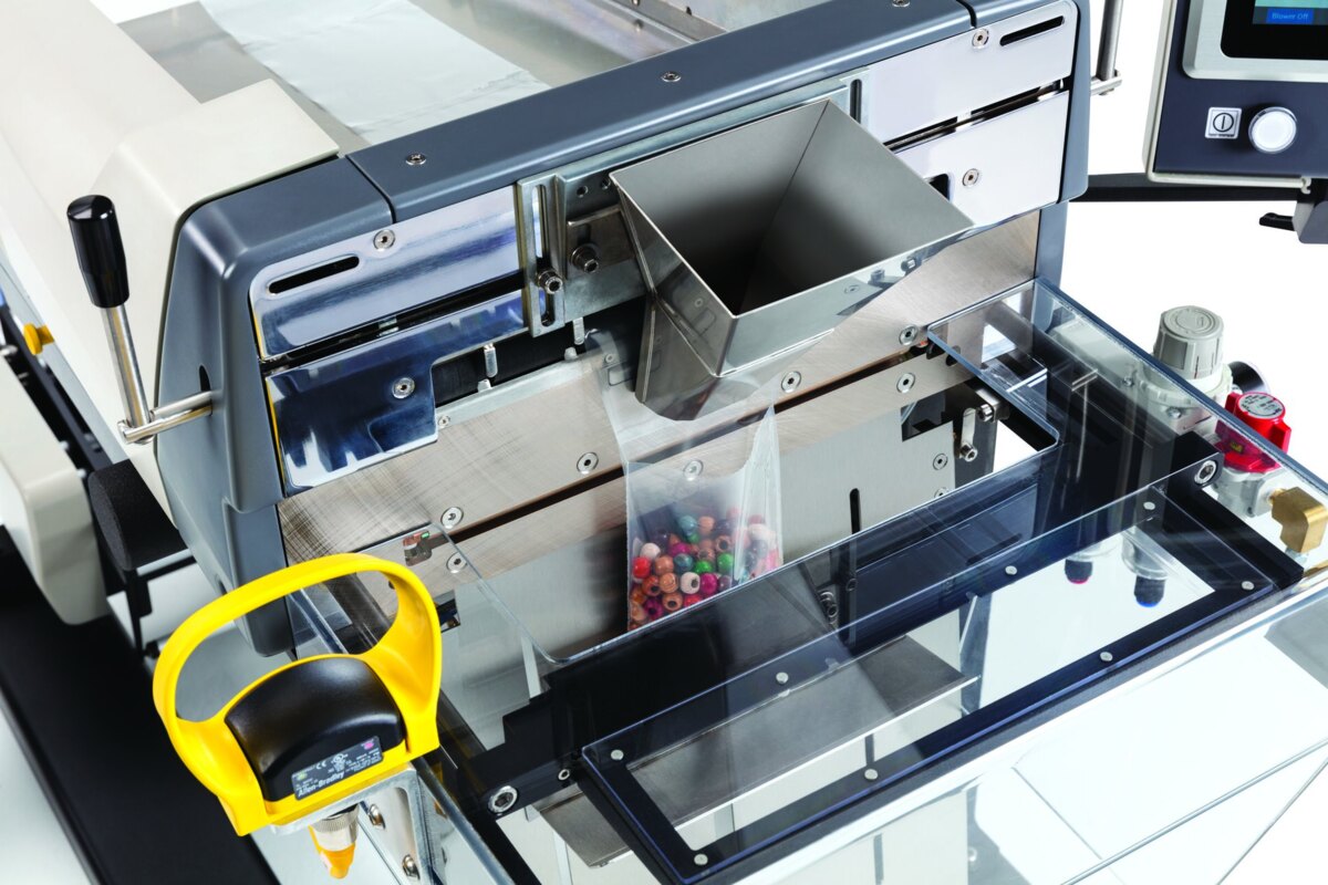 Standard infeed funnel mounted over the bag opening of an Autobag 500