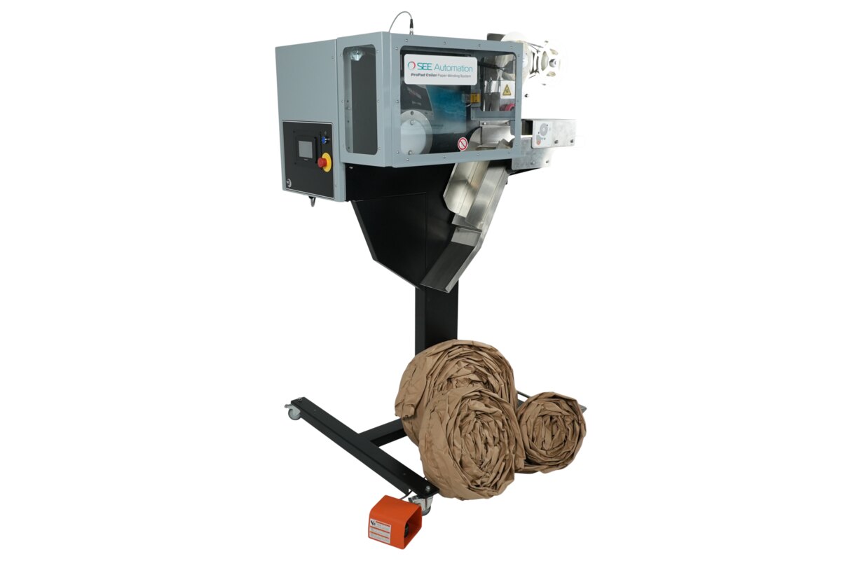 ProPad Coiler winding kraft paper cushioning into coils, with its footswitch